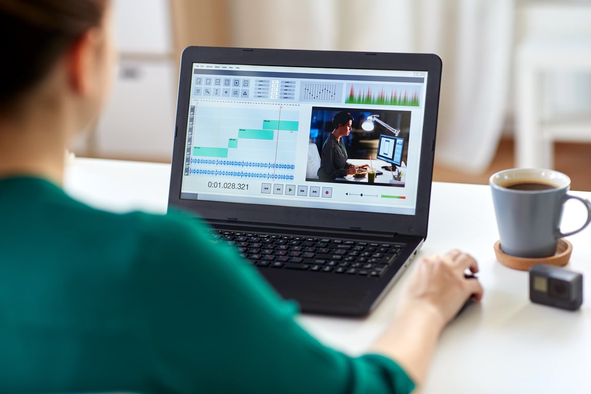 Woman with Video Editor Program on Laptop at Home